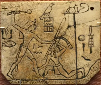 Ivory sandal label showing King Den striking a captive. Early Dynastic Period, 1st Dynasty. The scene includes the king’s name and associate